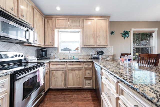 211 Anchor Dr, Freeport, TX 77541 - kitchen featuring appliances with stainless steel finishes, light brown cabinetry, light stone counters, decorative backsplash, and dark wood-style floors