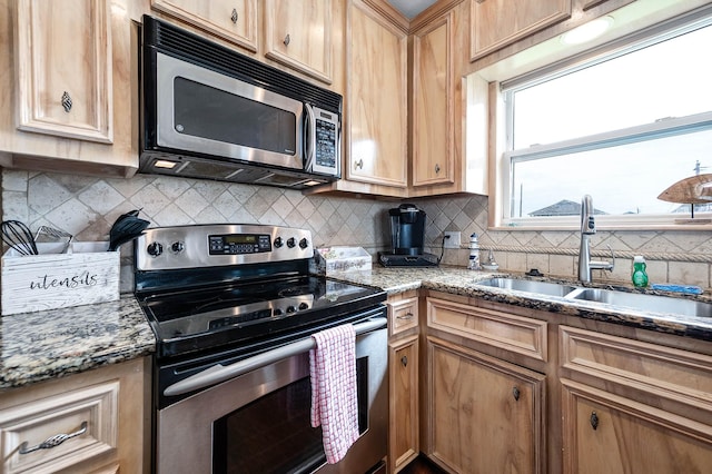 211 Anchor Dr, Freeport, TX 77541 - kitchen featuring stainless steel appliances, tasteful backsplash, and light stone counters
