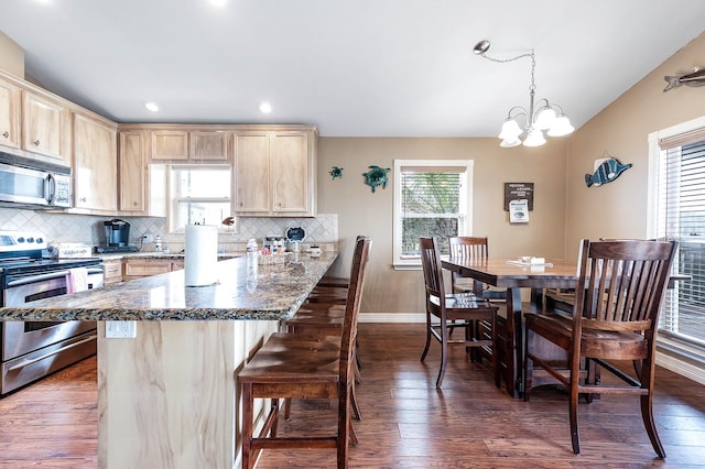 211 Anchor Dr, Freeport, TX 77541 - kitchen featuring appliances with stainless steel finishes, light brown cabinets, a chandelier, backsplash, and recessed lighting