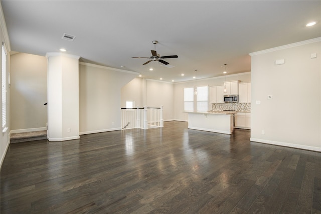 9624 Cambridge Manor Ln, Houston, TX 77045 - unfurnished living room featuring a ceiling fan, ornamental molding, dark wood-type flooring, and recessed lighting