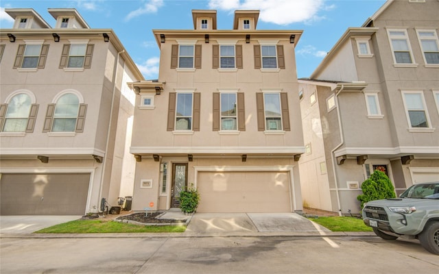 9624 Cambridge Manor Ln, Houston, TX 77045 - italianate house featuring stucco siding, a garage, and driveway