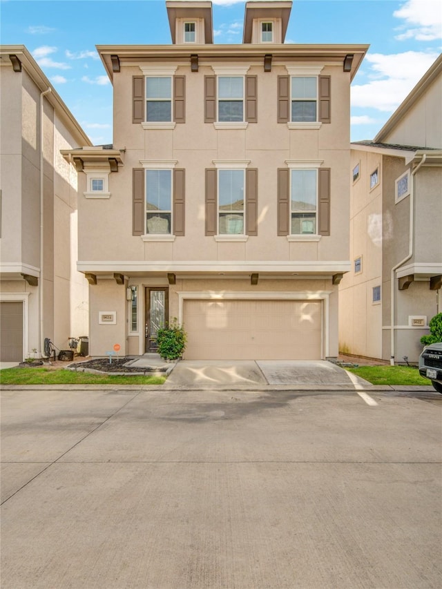 9624 Cambridge Manor Ln, Houston, TX 77045 - italianate home featuring stucco siding, concrete driveway, and an attached garage