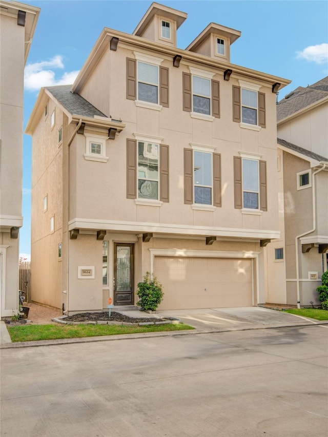 9624 Cambridge Manor Ln, Houston, TX 77045 - view of front facade featuring stucco siding, a garage, and driveway