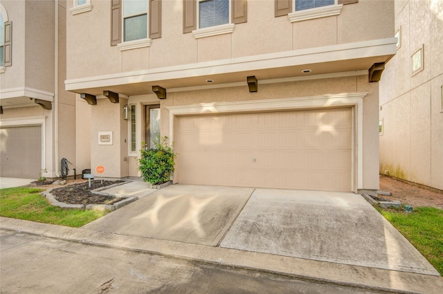 9624 Cambridge Manor Ln, Houston, TX 77045 - view of front of house with a garage, driveway, and stucco siding