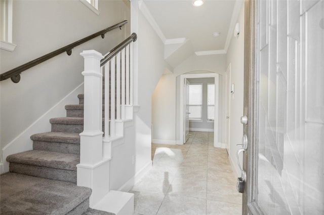9624 Cambridge Manor Ln, Houston, TX 77045 - foyer featuring arched walkways, ornamental molding, stairway, light tile patterned floors, and recessed lighting
