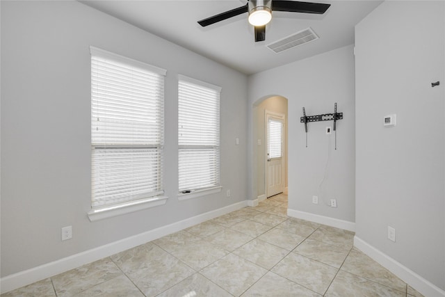 9624 Cambridge Manor Ln, Houston, TX 77045 - spare room featuring ceiling fan, arched walkways, and light tile patterned floors