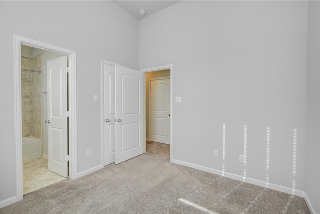 9624 Cambridge Manor Ln, Houston, TX 77045 - unfurnished bedroom with carpet floors, a towering ceiling, and ensuite bath