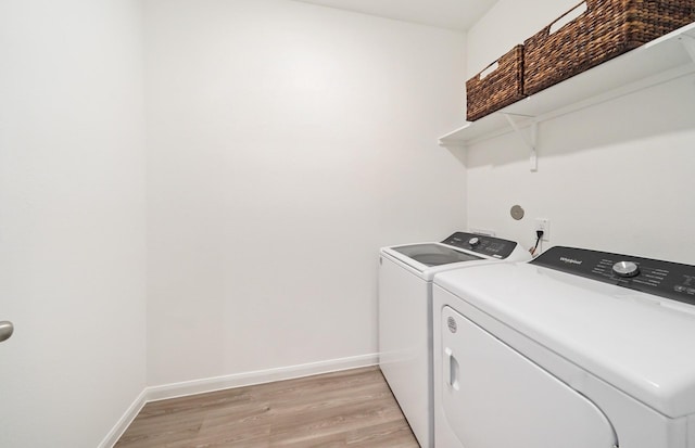 25713 Merino Ct, Magnolia, TX 77355 - laundry room featuring independent washer and dryer and light wood-type flooring