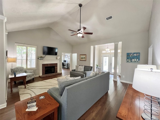 1407 Evening Cloud Ct, Katy, TX 77450 - living area featuring ceiling fan, dark wood-style flooring, a brick fireplace, vaulted ceiling, and ornate columns