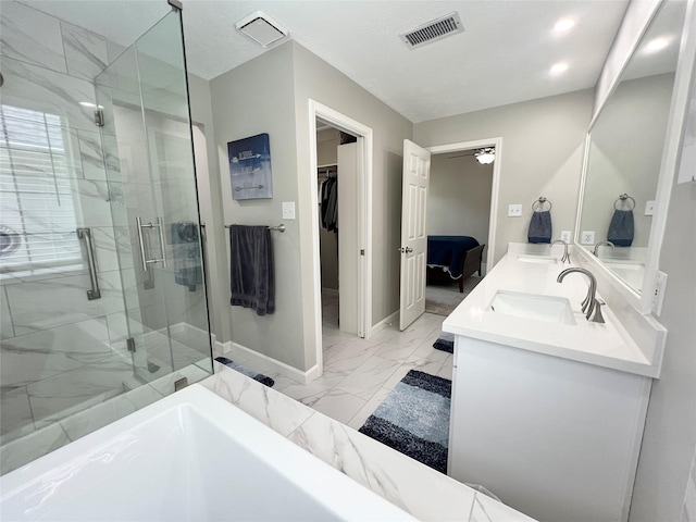 1407 Evening Cloud Ct, Katy, TX 77450 - bathroom featuring marble look tile flooring, a shower stall, double vanity, a spacious closet, and recessed lighting