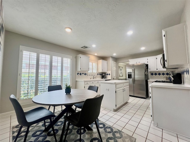 1407 Evening Cloud Ct, Katy, TX 77450 - dining room featuring recessed lighting, light tile patterned floors, and a textured ceiling