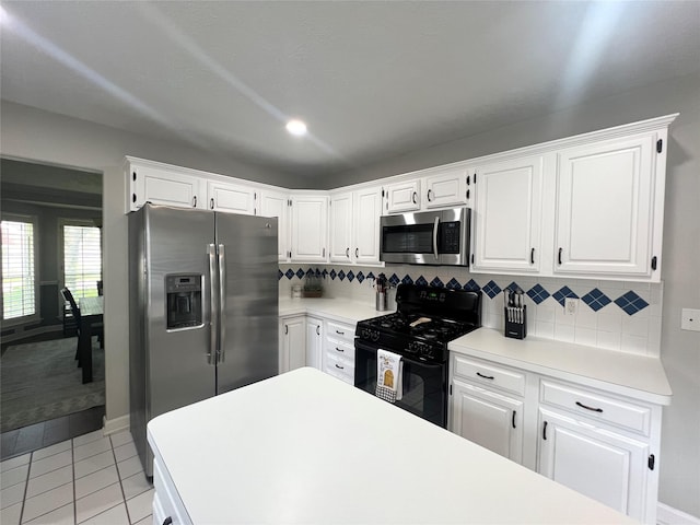 1407 Evening Cloud Ct, Katy, TX 77450 - kitchen with stainless steel appliances, backsplash, white cabinetry, and light countertops