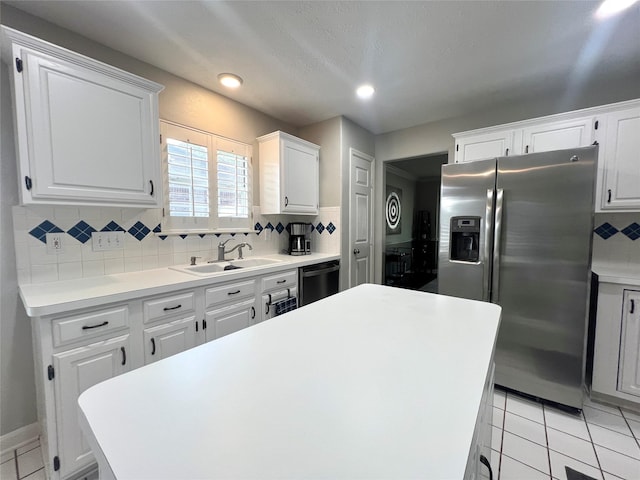 1407 Evening Cloud Ct, Katy, TX 77450 - kitchen with stainless steel fridge, backsplash, white cabinetry, dishwasher, and recessed lighting