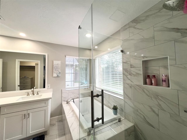 1407 Evening Cloud Ct, Katy, TX 77450 - bathroom with marble look tile flooring, a garden tub, vanity, and recessed lighting