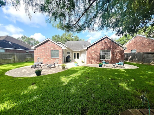 1407 Evening Cloud Ct, Katy, TX 77450 - back of house featuring brick siding, a patio area, a chimney, and a fenced backyard