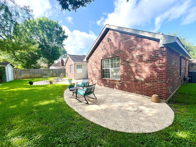1407 Evening Cloud Ct, Katy, TX 77450 - rear view of house featuring brick siding, a patio, a storage shed, and a fenced backyard