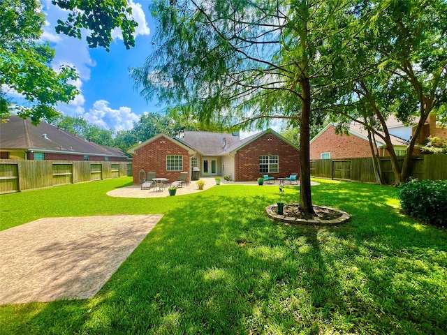 1407 Evening Cloud Ct, Katy, TX 77450 - rear view of house featuring brick siding, a patio, and a fenced backyard