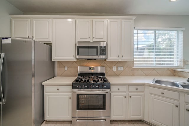 13430 Magnolia Crest Ln, Houston, TX 77070 - kitchen with stainless steel appliances, white cabinets, and tasteful backsplash