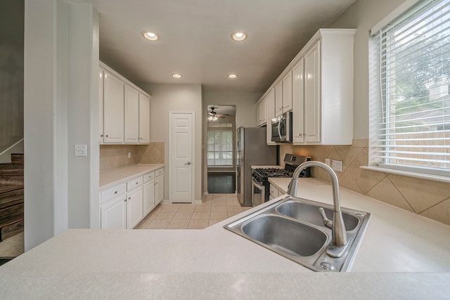 13430 Magnolia Crest Ln, Houston, TX 77070 - kitchen with stainless steel appliances, recessed lighting, white cabinetry, decorative backsplash, and light tile patterned floors