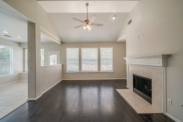 13430 Magnolia Crest Ln, Houston, TX 77070 - unfurnished living room featuring a ceiling fan, healthy amount of natural light, a fireplace, wood finished floors, and high vaulted ceiling