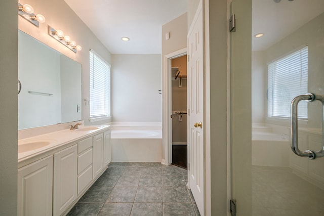 13430 Magnolia Crest Ln, Houston, TX 77070 - bathroom with a garden tub, double vanity, tile patterned flooring, and a spacious closet