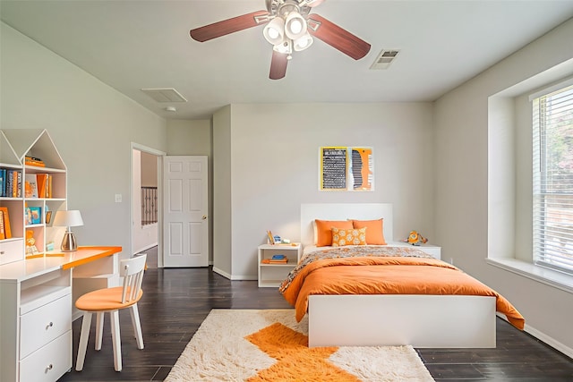 13430 Magnolia Crest Ln, Houston, TX 77070 - bedroom with dark wood-style floors, a ceiling fan, and built in desk