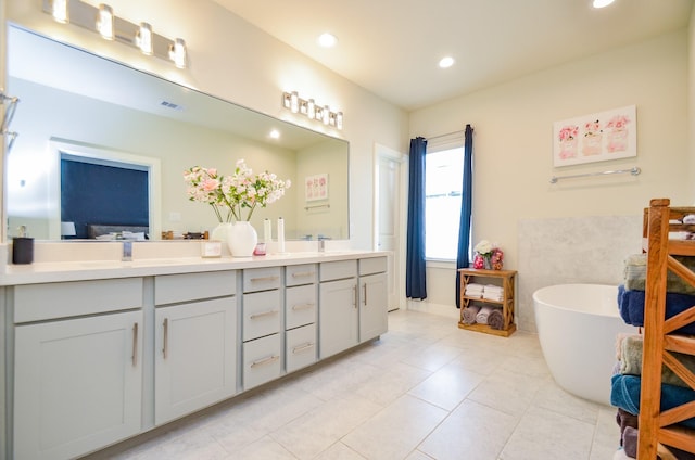 4915 Ave J, Houston, TX 77011 - bathroom with double vanity, a freestanding tub, recessed lighting, and tile patterned flooring