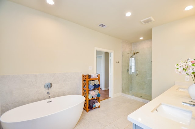 4915 Ave J, Houston, TX 77011 - full bath with a shower stall, a freestanding bath, double vanity, recessed lighting, and tile patterned floors