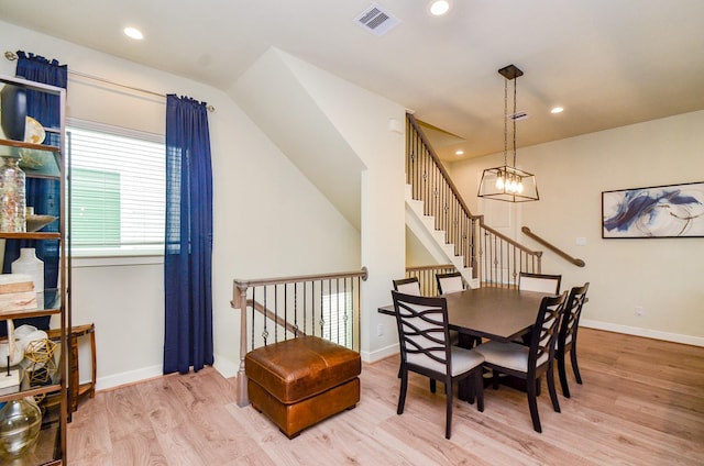 4915 Ave J, Houston, TX 77011 - dining room featuring wood finished floors, lofted ceiling, stairway, a chandelier, and recessed lighting