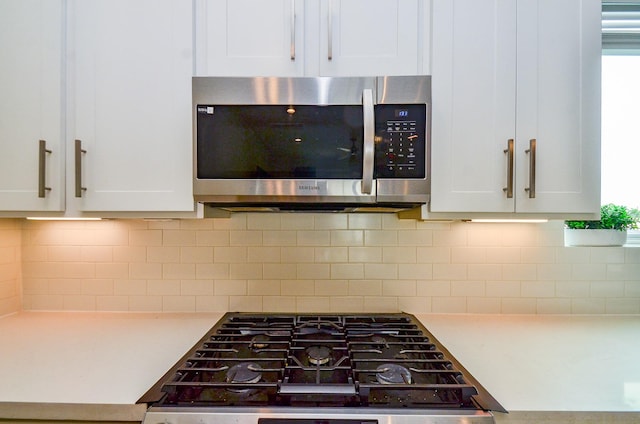 4915 Ave J, Houston, TX 77011 - kitchen view of stainless steel microwave, white cabinets, and light countertops