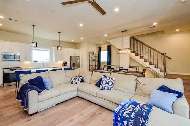 4915 Ave J, Houston, TX 77011 - living area featuring light wood-style floors, a ceiling fan, recessed lighting, and stairway
