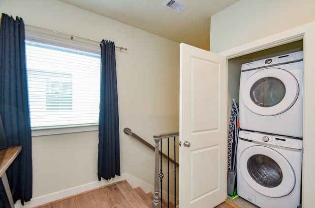 4915 Ave J, Houston, TX 77011 - laundry room with stacked washing machine and dryer and wood finished floors