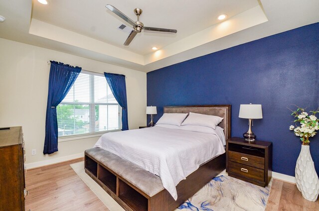 4915 Ave J, Houston, TX 77011 - bedroom featuring a tray ceiling, wood finished floors, recessed lighting, and a ceiling fan