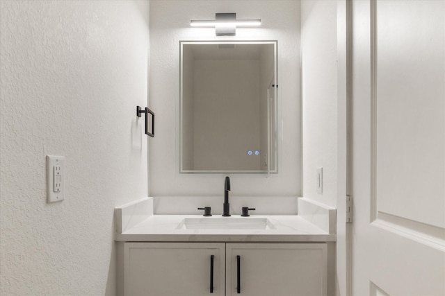 131 S Virginia Ave, La Porte, TX 77571 - bathroom with vanity and a textured wall