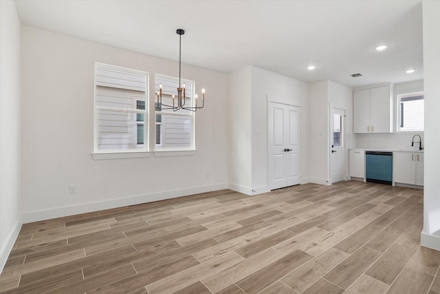 131 S Virginia Ave, La Porte, TX 77571 - unfurnished dining area featuring a chandelier, light wood-type flooring, and recessed lighting