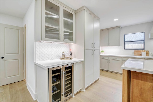 2831 Shadowdale Dr, Houston, TX 77043 - indoor dry bar with wine cooler, light wood-type flooring, backsplash, and recessed lighting