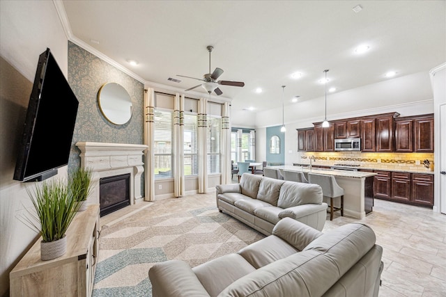 19427 Stanton Lake Dr, Cypress, TX 77433 - living area featuring a ceiling fan, crown molding, recessed lighting, and a glass covered fireplace