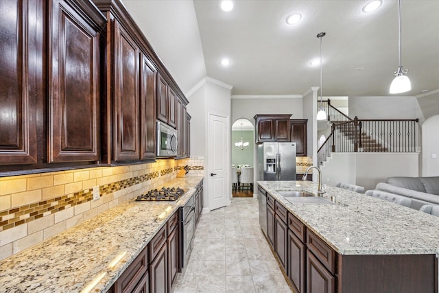 19427 Stanton Lake Dr, Cypress, TX 77433 - kitchen with stainless steel appliances, ornamental molding, a center island with sink, decorative backsplash, and light stone counters