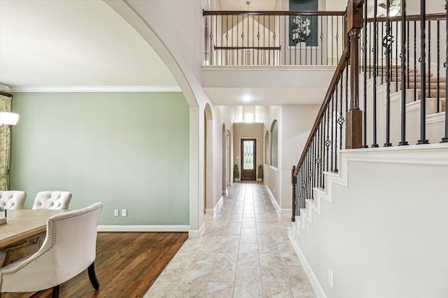 19427 Stanton Lake Dr, Cypress, TX 77433 - foyer featuring arched walkways, stairs, and ornamental molding