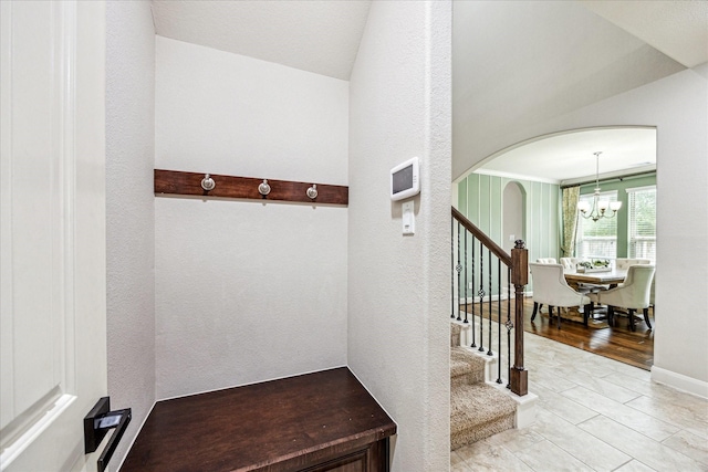 19427 Stanton Lake Dr, Cypress, TX 77433 - mudroom with a chandelier, arched walkways, tile patterned floors, and a textured wall