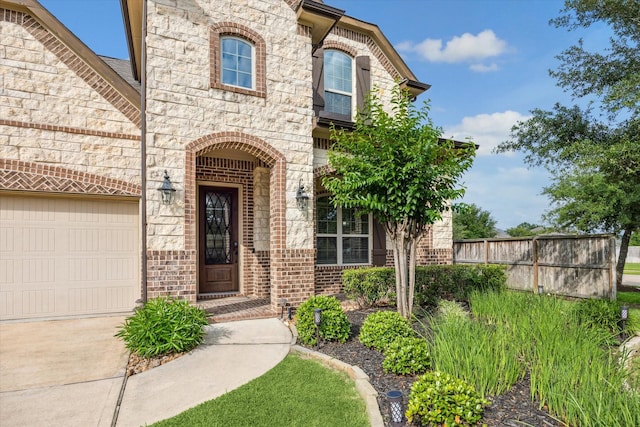 19427 Stanton Lake Dr, Cypress, TX 77433 - doorway to property featuring stone siding, a garage, brick siding, and concrete driveway
