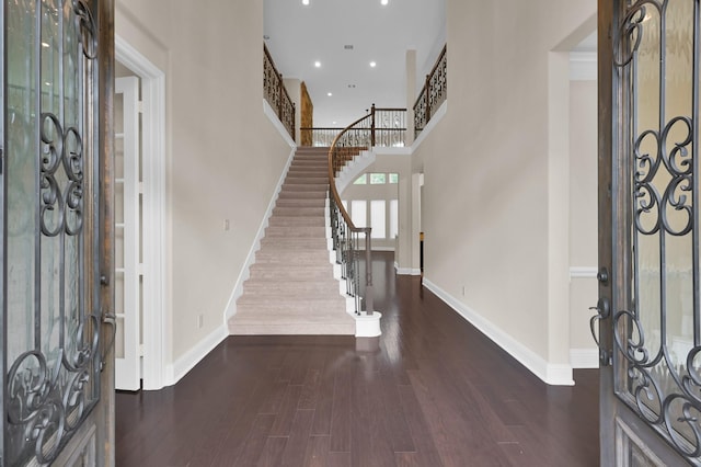 3403 Wooded Ln, Conroe, TX 77301 - foyer with stairs, dark wood-style flooring, recessed lighting, and a towering ceiling