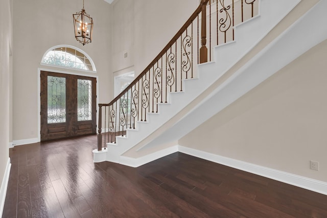 3403 Wooded Ln, Conroe, TX 77301 - entrance foyer featuring a chandelier, a towering ceiling, stairs, and wood finished floors