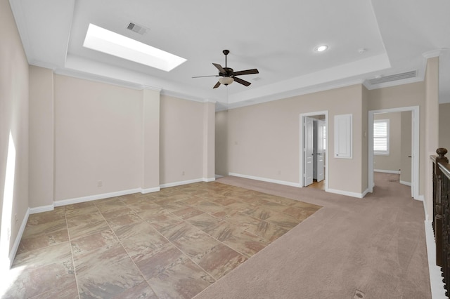 3403 Wooded Ln, Conroe, TX 77301 - empty room featuring a tray ceiling, a ceiling fan, a skylight, and recessed lighting