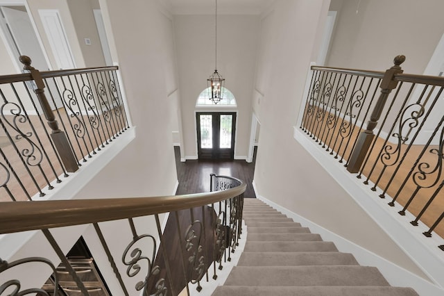3403 Wooded Ln, Conroe, TX 77301 - entrance foyer with a towering ceiling, wood finished floors, a chandelier, and crown molding