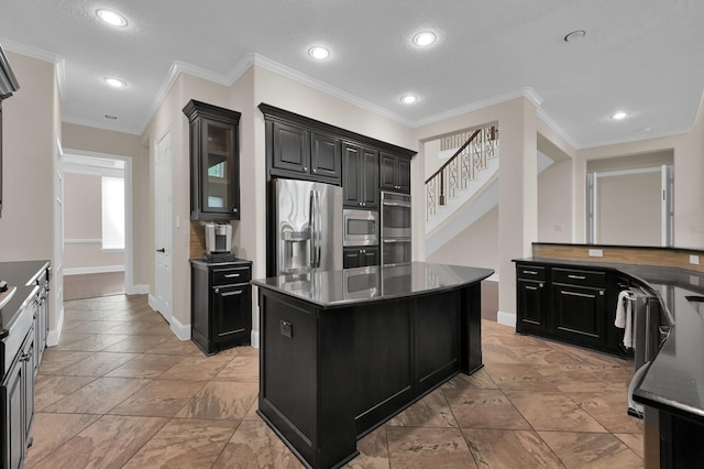 3403 Wooded Ln, Conroe, TX 77301 - kitchen with stainless steel appliances, dark cabinets, a kitchen island, recessed lighting, and crown molding