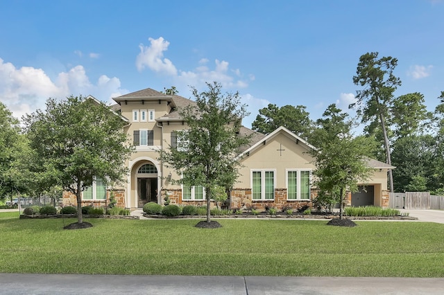 3403 Wooded Ln, Conroe, TX 77301 - view of front facade featuring stucco siding, driveway, an attached garage, and stone siding