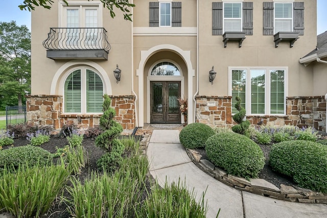 3403 Wooded Ln, Conroe, TX 77301 - doorway to property featuring french doors, stone siding, and stucco siding