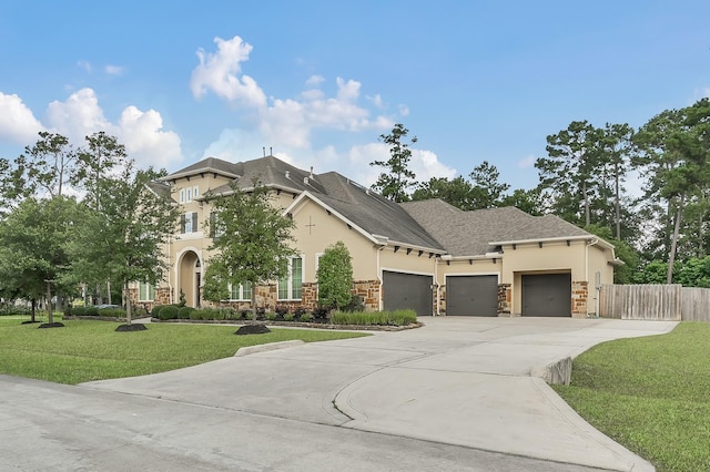 3403 Wooded Ln, Conroe, TX 77301 - view of front of property featuring stucco siding, stone siding, an attached garage, and driveway