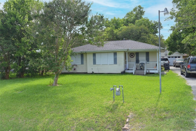 2104 Westward Ln, Marque, TX 77568 - view of front of property featuring a front lawn, roof with shingles, and covered porch